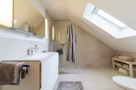 Das Schlafzimmerbad: Klar strukturiert, stilvoll modernisiert und mit großzügiger Dusche – ideal für den täglichen Komfort.