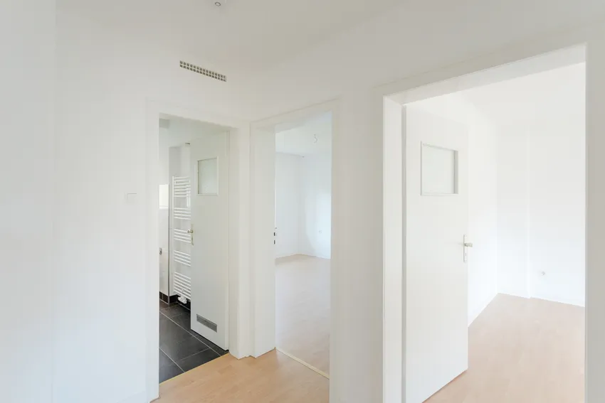 Blick vom Flurbereich in das Bad, den Wohnraum und einen weiteren Raum 