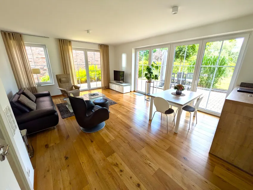 Der Wohnzimmer- und Essbereich mit Blick in den großen Garten 