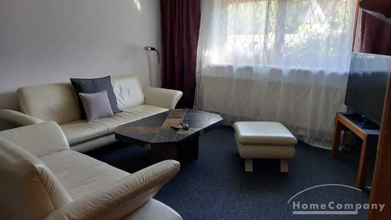 Wohnung im Souterrain eines Reihenhauses, großes Wohnzimmer mit TV