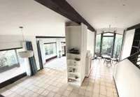 Giebelhoch offenes Wohnzimmer mit Kachelofen und Fernblick