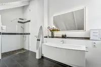 Bathroom with a tub and shower