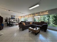 Großes, helles Wohnzimmer mit Glasfront zum Garten