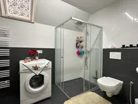 Badezimmer mit Dusche und Waschmaschinenanschluss